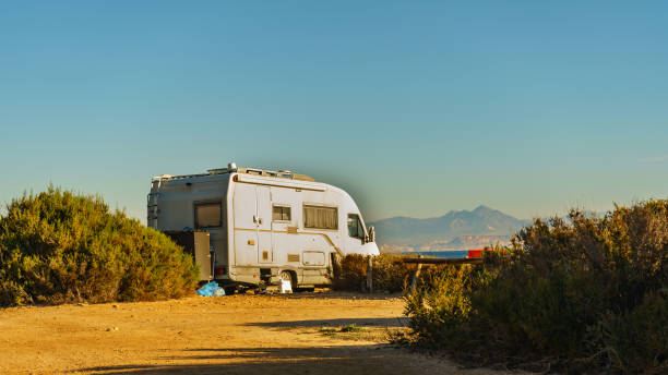 istock Camper car on beach, camping on seashore 1292763238