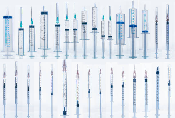 Medical Syringe with needle isolated on white, macro. Many different syringes in different positions with and without liquids.