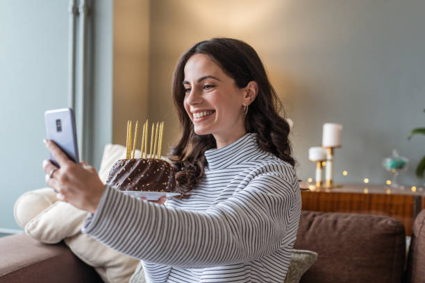 istock Young woman having online birthday celebration 1292764331