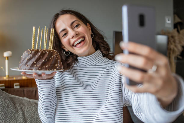 istock Young woman having online birthday celebration 1292764333