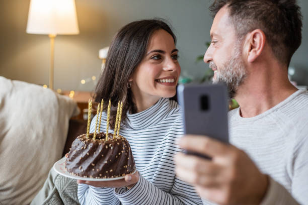 istock Couple at home, having online birthday celebration 1292764376