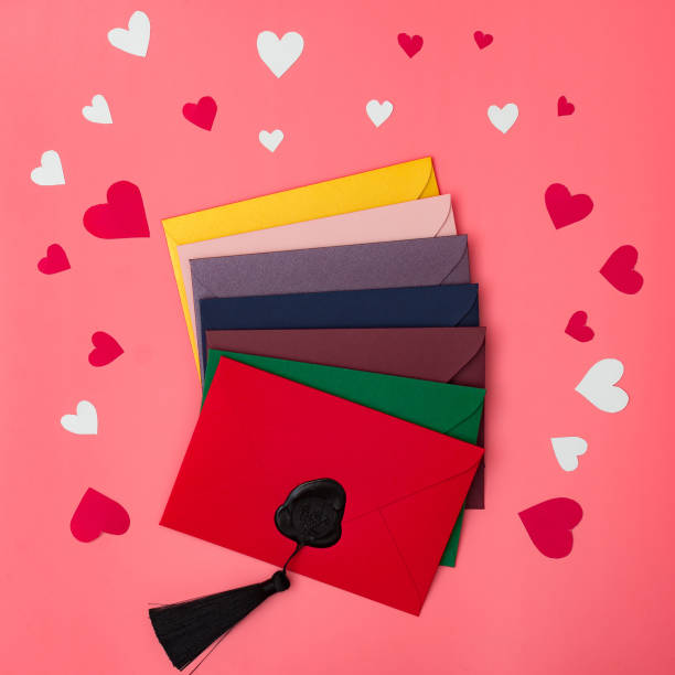 istock Love letters. Multicolored envelopes on a red background with hearts. 1292764424