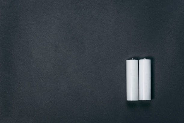 istock Several AA blank white  batteries on black paper background 1292764879