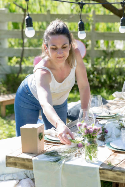 istock Beautiful woman decorating and setting the table 1292765764