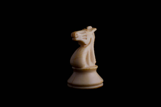 istock one side light on white knight chess piece in black background 1292765784