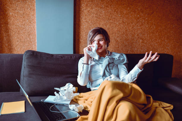 istock Female Wiping Runny Nose While Working At Home 1292766214