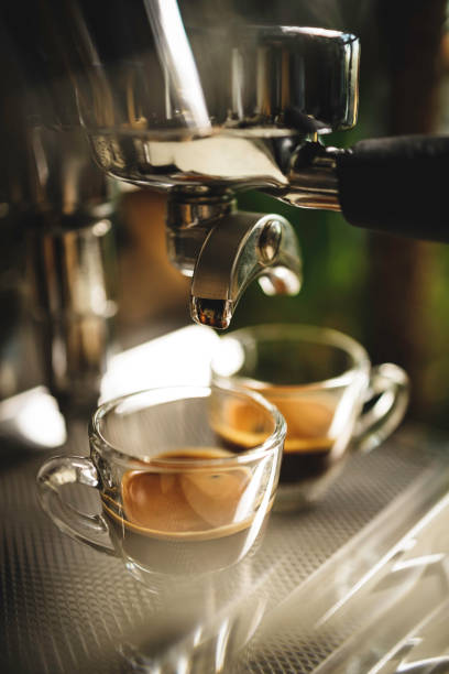 istock two cups of espresso being poured from an espresso machine 1292766967