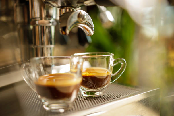 istock two cups of espresso being poured from an espresso machine 1292766969