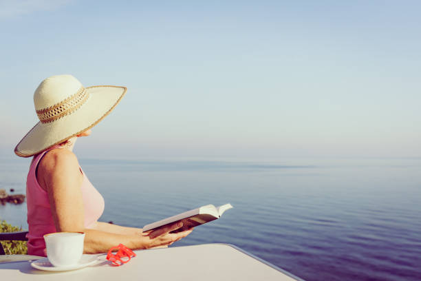 istock Woman on sea read book, relaxing 1292769518