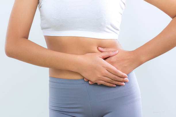 istock woman feeling problems intestine with food poison 1292770073