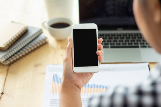 istock Holding a mobile screen on the desk 1292770130