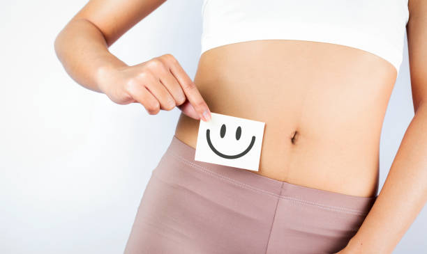 Women Stomach Health. Healthy Female With Beautiful Fit Slim Body  Holding White Card With Happy 
Smiley Face In Hands Good Digestion Concepts. High Resolution Women Stomach Health. Healthy Female With Beautiful Fit Slim Body  Holding White Card With Happy 
Smiley Face In Hands Good Digestion Concepts. High Resolution oligosaccharide stock pictures, royalty-free photos & images