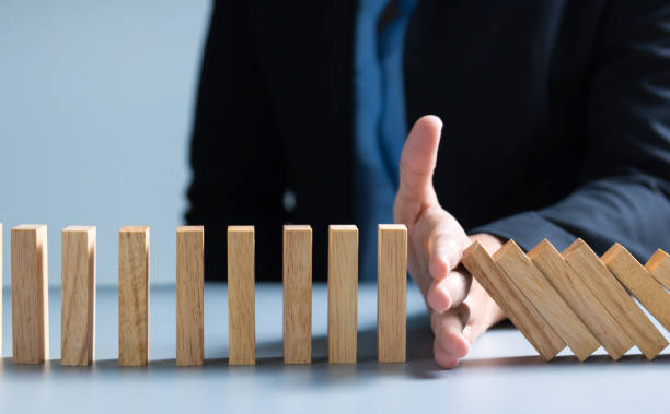 istock Risk management Businesswoman stop domino effect. leadership has solution for problem. 1292771203