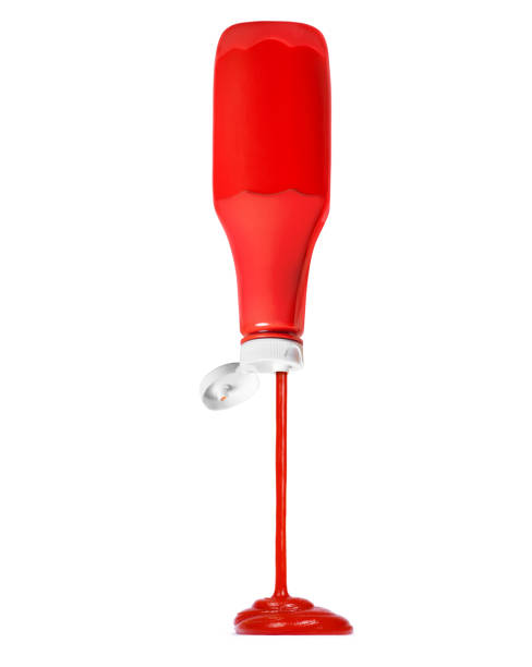 istock Ketchup flows from a plastic red bottle, isolated on white background 1292772301