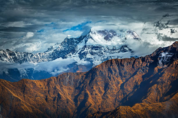 Snow covered mountain peak Chaukamba in clouds - the Himalayas, India