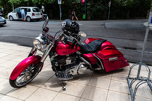 Mondsee, Austria - August 5, 2017: Pink Harley Davidson parked on street during vintage Motorcycles Fair.