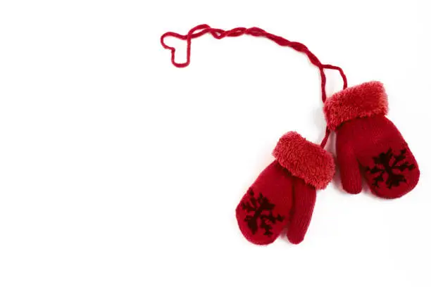 Pair of red winter mittens isolated on white background.