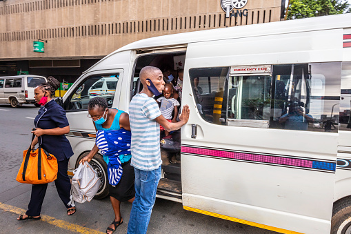 Commuters seen leaving the taxi in Johannesburg, Johannesburg is also known as Jozi, Jo'burg or eGoli and is the largest city in South Africa.