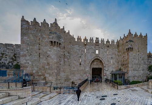 Jerusalem, Israel - December 17th, 2020: The sun rise over the Damascus gate of the old city of Jerusalem walls