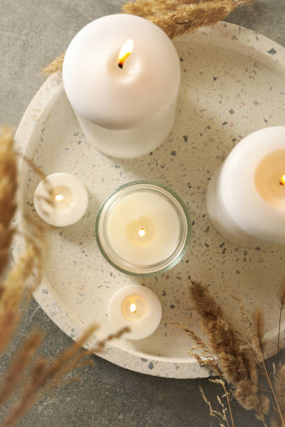 istock Tray with scented candles and reed on gray table 1292775639