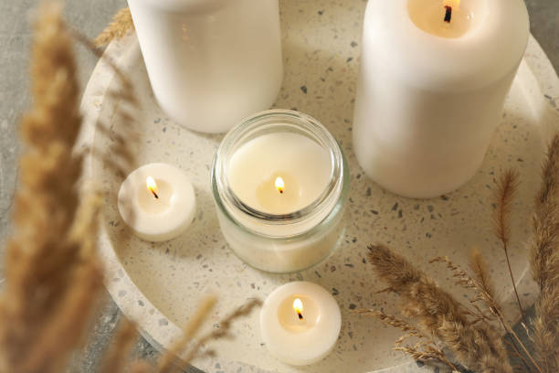 istock Tray with scented candles and reed on gray table 1292775645