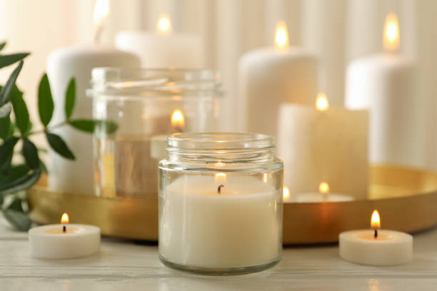 istock Burning scented candles for relax on white wooden table 1292775663