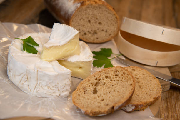 istock Camembert cheese on a wooden background 1292775738