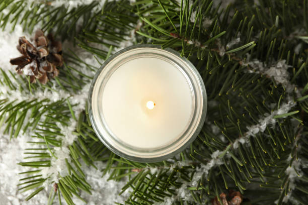 istock Scented candle, pine branches and snow, top view 1292775896