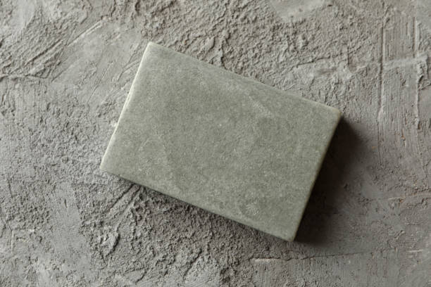 istock Piece of natural handmade soap on gray background 1292776247