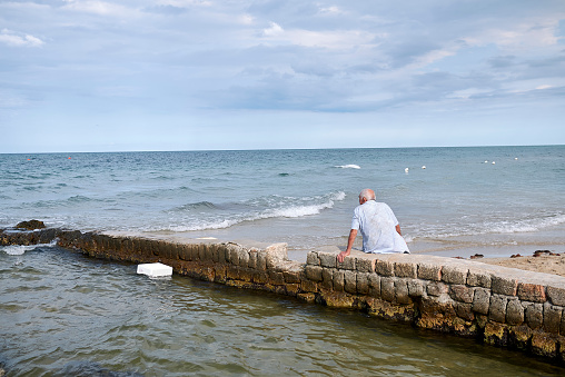 Lido Morelli, Italy - September 03, 2020 : Man resting by the sea