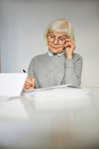 istock Concentrated woman looking at the documents on the desk 1292777406