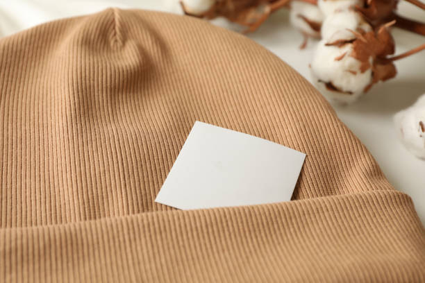 istock Stylish beanie and cotton on white background, close up 1292777510