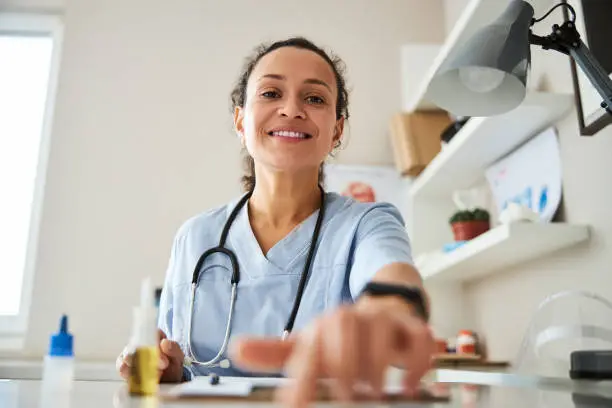 Photo of Medical specialist reaching out to turn-off a device