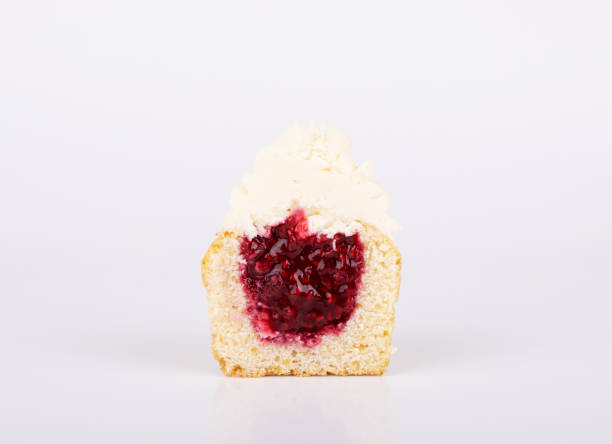 istock The cupcake is cut in half, with cherry filling and white vanilla icing 1292778349