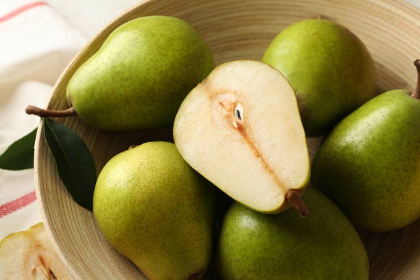 istock Bowl with green pears and kitchen towel, close up 1292778626