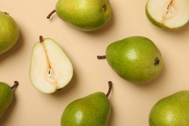 istock Fresh green pears on beige background, top view 1292779454