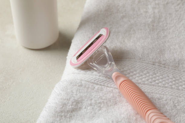 istock Towel, razor and spray on textured table 1292779822