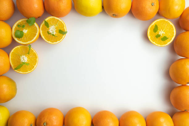 istock frame of fresh whole and sliced oranges on white background 1292780614