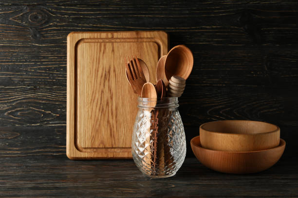 istock Different wooden kitchenware on wooden background, space for text 1292782002
