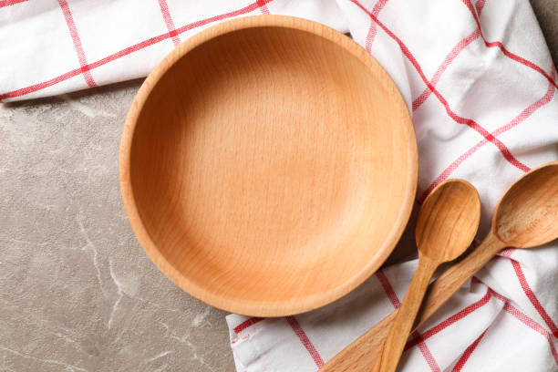 istock Kitchen napkin with wooden dishes on gray table 1292782119