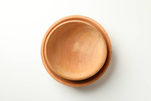 istock Two wooden bowls on white background, top view 1292782141