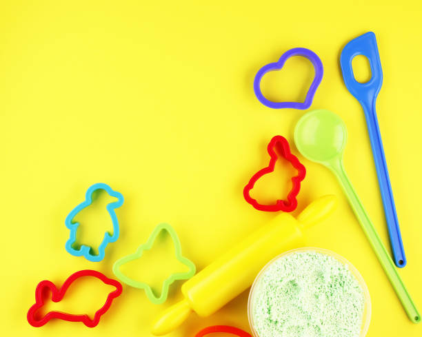 istock Colorful baking pans for Christmas gingerbread on a yellow background 1292784108