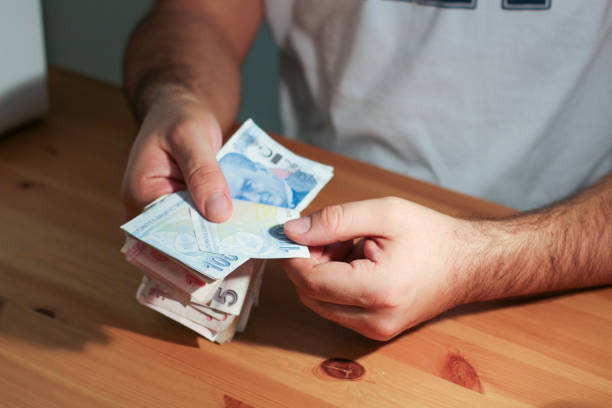 istock Male hand on the table is counting money, banknotes 1292785276