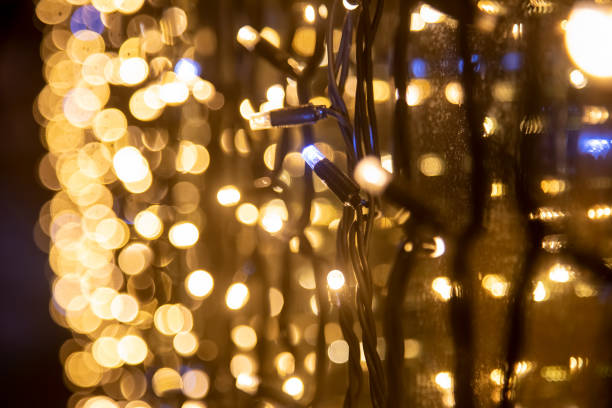 istock yellow wall garland perspective close-up soft focus. Festive blurred backdrop. 1292786439