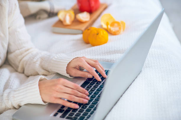 istock Close up picture of womans hands typing 1292786704