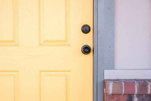 Welcoming, bright, yellow door on a residential home.