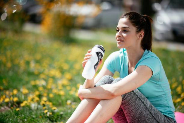 istock Young woman resting after training in the park 1292789114