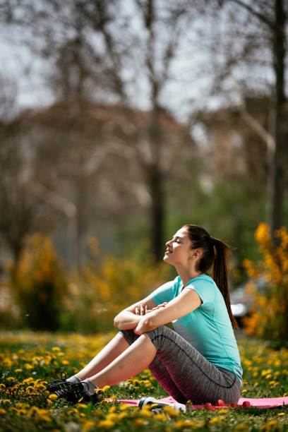 istock Young woman resting after training in the park 1292789338