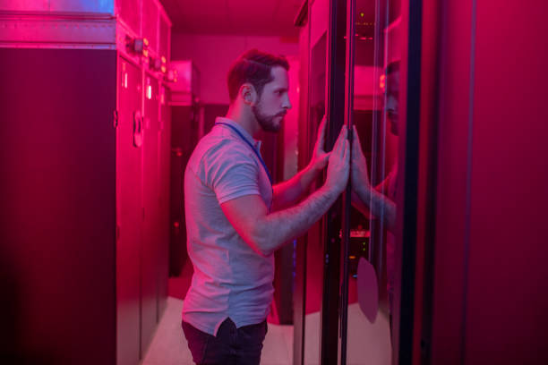 istock Man opening closet in data center 1292790167