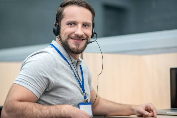 istock Smiling man in gray tshirt and headphones 1292790285